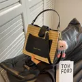Straw bucket bag with black leather trim and a pink plush monster charm - With Pendant / Black