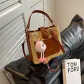 Straw and brown leather bucket bag with top handle and crossbody strap plus pink charm - No Pendant / Brown