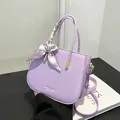 Lavender lychee leather crossbody bag with silk scarf handle and fashion branding - Purple