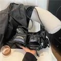 Glossy black moto-style shoulder bag with multi-pocket utilitarian wax leather design - Black