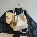Chic beige lychee leather bucket bag with cute elephant charm and long shoulder strap - White
