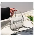 Détail du mini sac blanc à motif litchi avec rivets argentés et bandoulière chaîne - Blanc