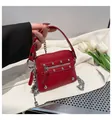 Détail du mini sac rouge en cuir grainé avec rivets argentés et bandoulière en chaîne - Rouge