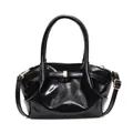 Detail of black glossy tote bag featuring gold buckle and textured wing-shaped sides - Black