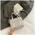 Silver glitter bucket bag with metallic trim, featuring a square logo plate and top handles - Small No Charm Silver