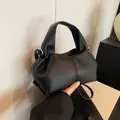 Black pleated cloud bag with pebble leather texture and gold hardware for women - Black