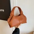 Caramel brown ruched cloud handbag with litchi texture and gold metal ring detail - Brown
