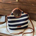 Knitted tote bag with navy blue and white stripes featuring brown leather straps - Black