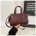 Chic burgundy leather handbag with golden hardware and adjustable crossbody strap - Wine Red (Without Pendant)