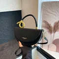 Minimalist black leather crescent bag with artistic gold metal handle and shoulder strap - Black