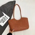 Brown woven tote bag with herringbone texture and metal feet for professional women - Brown
