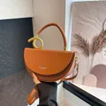 Brown leather half-moon handbag with gold knot ring detail and adjustable strap - Brown