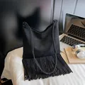 Bohemian style black suede shoulder bag featuring long fringe tassels for daily commute - Black