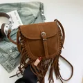 Brown faux suede bohemian saddle bag with long tassels and silver buckle detail - Brown