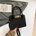 Matte black leather tote bag with gold hardware lock and detachable crossbody strap - One Size / Black