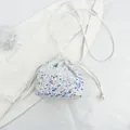 Mini sequin drawstring bucket bag with iridescent blue and purple accents - White