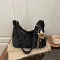 Retro black faux suede hobo bag with cute bear charm on a soft knit blanket - Black With Pendant