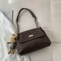 Retro dark brown matte shoulder bag with metallic buckle and plush bunny charm - With Pendant / Brown