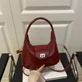Fashionable wine red patent leather handbag with gold twist lock and adjustable strap - Red