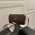 Dark brown glossy cylinder bag with gold fashion hardware and patent leather finish - Glossy Style / Brown