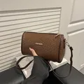 Brown woven cylindrical shoulder bag with gold metal fashion logo and leather strap - Woven Texture / Woven Brown