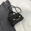 Elegant black faux leather crossbody bag with gold chain strap and top handle - Black