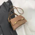 Elegant tan faux leather crossbody bag with gold chain accent and adjustable strap - Khaki