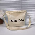 Off-white canvas tote bag with black TOTE BAG print and adjustable shoulder straps - Off-white