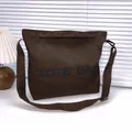 Dark coffee brown canvas tote bag with black lettering and adjustable shoulder strap - Brown