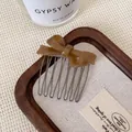 Brown resin bow hair comb with gold-tone metal teeth in an amber-like finish - Milk Coffee Bow Hair Comb