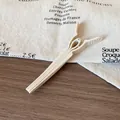 Creamy beige matte hair root clip for volume with non-slip handle on wooden desk - Off White