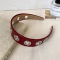 Modern dark red faux leather headband with metallic silver grommets for a stylish look - Red Eyelet