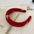 Handmade red plush headband featuring cream bow embroidery and thick padded design - Red Bow Plush