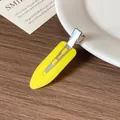 Minimalist yellow acetate teardrop hair clip with a stylish matte finish on a wood background - Yellow