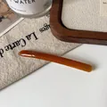 Slim amber acetate hair clip with France Handmade text in a French minimalist style - Orange Barrette