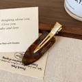 Acetate waterdrop hair clip with dark brown tortoiseshell pattern and gold metal base - Blue-Brown