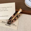 French style tortoise shell acetate hair clip with golden metal clip and logo detail - Light Leopard