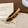Tortoiseshell resin hair clip with gold metal base featuring Creation France engraving - Dark Leopard Print