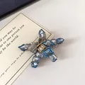 Elegant butterfly hair clip featuring blue crystals and silver bow on artistic backdrop - Azure Crystal Sea Star Hair Clip