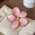 Pink gradient flower hair claw clip with gold metal trim on beige canvas background - Dark Pink Flower Claw