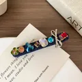 Luxe hairpin featuring colorful rhinestones and a blue denim texture with silver bow detail - Dark Denim Rhinestone Hair Clip