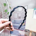 Matte black wavy headband with non-slip teeth for women shown in a home setting - Black Large Wave