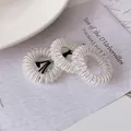 Sparkling silver telephone wire hair spiral ties on minimalist floral card set - Silver