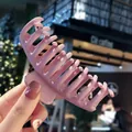 Large matte dusty rose hair claw clip for thick hair styling in a casual cafe setting - Smoke Pink