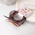 Set de gomas para el pelo elásticas de varios colores con lazos en tarjeta rosa decorada - Multicolor
