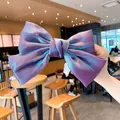 Iridescent purple oversized bow hair clip with textured metallic fabric finish - Purple
