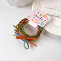Set de seis gomas de pelo de alta elasticidad con lazos en colores variados y vivos - Multicolor