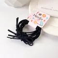 Set de seis gomas de pelo negras de alta elasticidad con nudos en una tarjeta - Negro