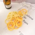 Yellow wavy elastic hair ties set in a transparent jar with various sunny shades - Yellow Series Wave