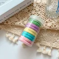 Pastel seamless nylon hair ties set in a clear jar on elegant white lace background - Spring Colors